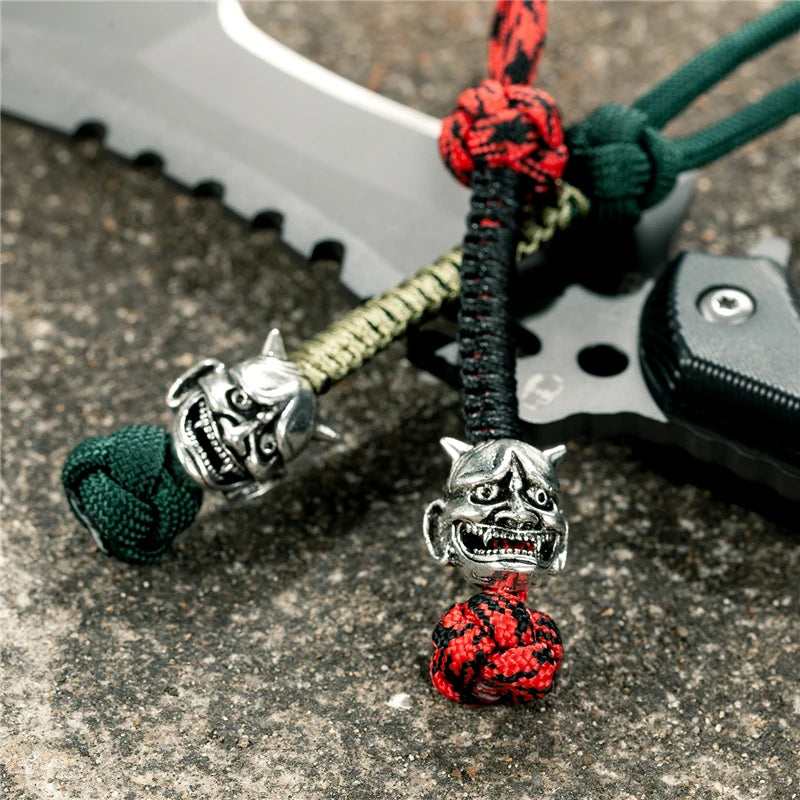 MKENDN New Design Japanese demon Evil mask Men Keychains Backbag Knife Pendant Men Survival Lanyard Rope Handmade Jewelry Gifts