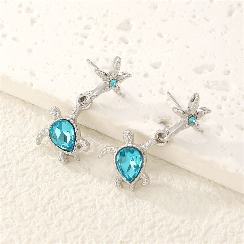 Boucles d'oreilles pendantes délicates en cristal bleu, forme étoile de mer et tortue, pour femme, idéales pour les vacances d'été. Bijou en métal, coquillage et étoile de mer, cadeau parfait pour une jeune fille.