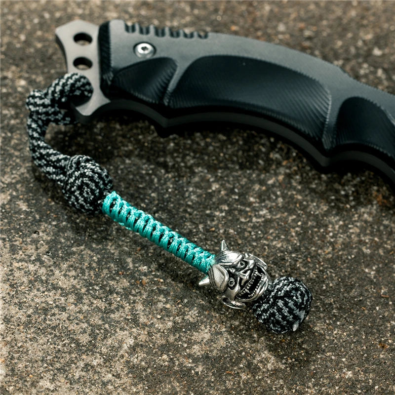 MKENDN New Design Japanese demon Evil mask Men Keychains Backbag Knife Pendant Men Survival Lanyard Rope Handmade Jewelry Gifts