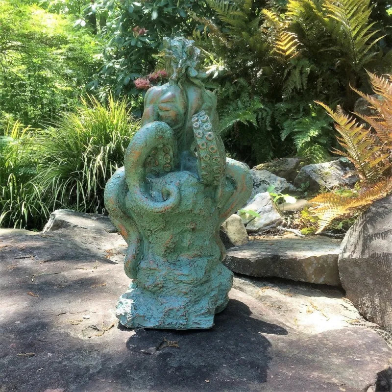 Nautical Statue of a Male Mermaid Sitting on Coastal Rock